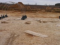 Can you find the structure in the foreground that has not yet been excavated?