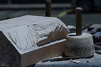 A marble capital with manufacturing marks left by the mallet and chisel, which also show signs of wear